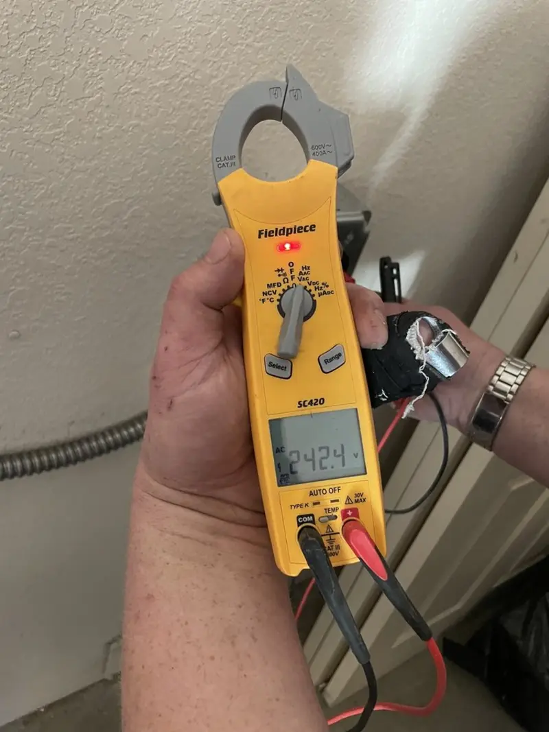 Voltage testing with clamp meter during Generator Installation in Castle Pines Village